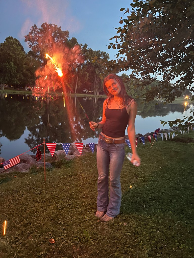 Travel family watches fireworks while visiting friends in Michigan by Adventurous Leila.