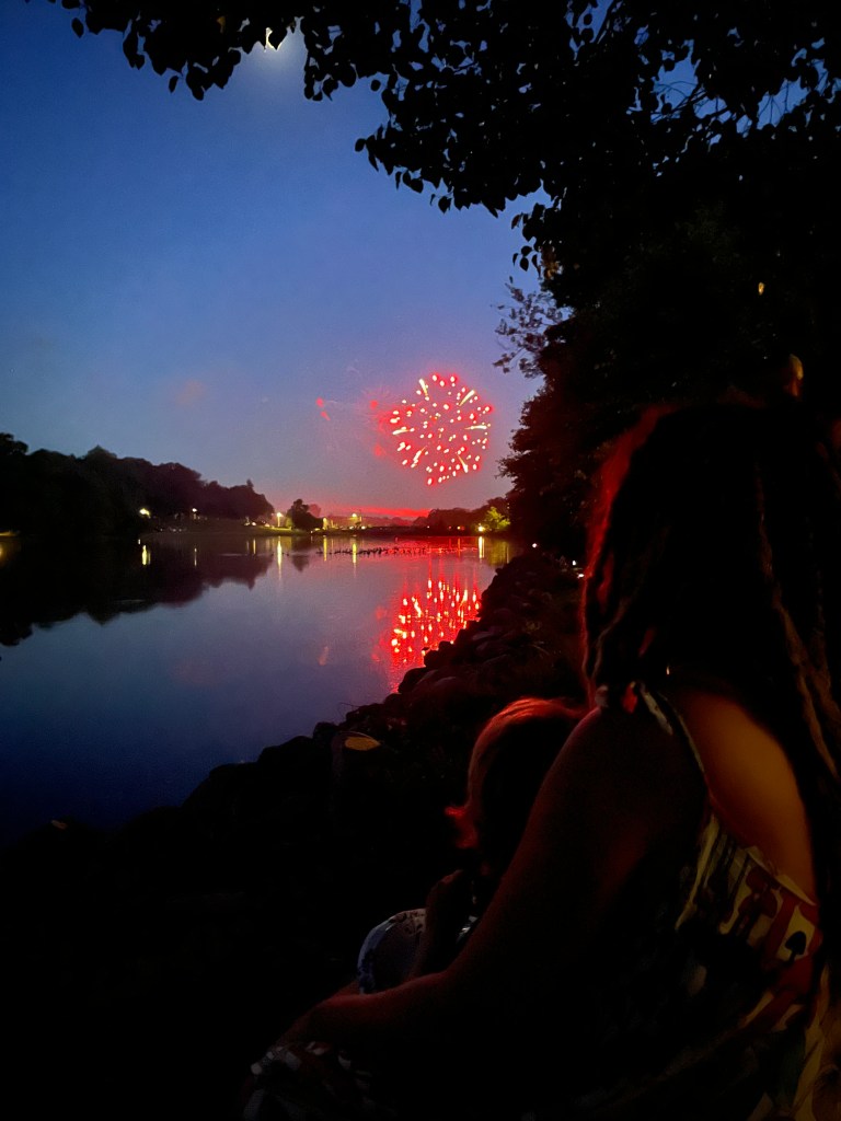 Travel family watches fireworks while visiting friends in Michigan by Adventurous Leila.