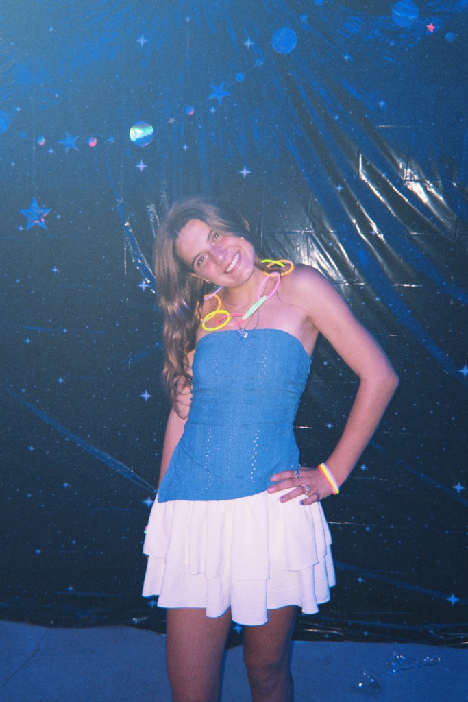 A Girl hangout out with a ton of their teen friends at a super fun bus travel family friendly event called Skoolie U.P. in the upper peninsula of Michigan. By Adventurous Leila.