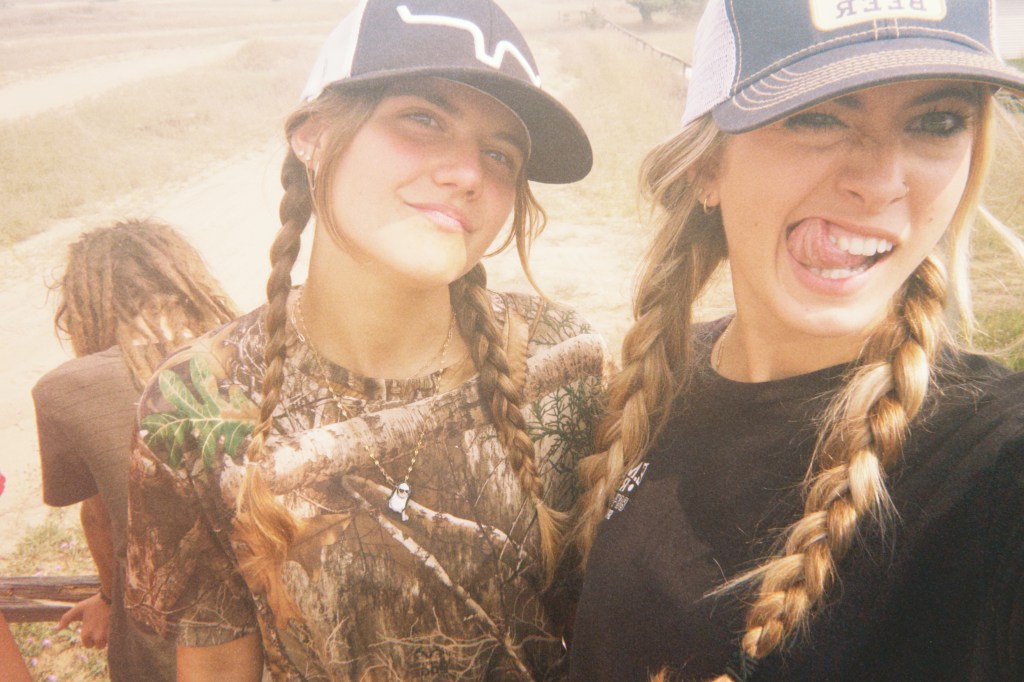 Girls hangout out with a ton of their teen friends at a super fun bus travel family friendly event called Skoolie U.P. in the upper peninsula of Michigan. By Adventurous Leila.