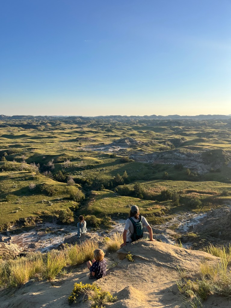 A photo of a family on a hike at Theodore Roosevelt national Park. By Adventurous Leila.
